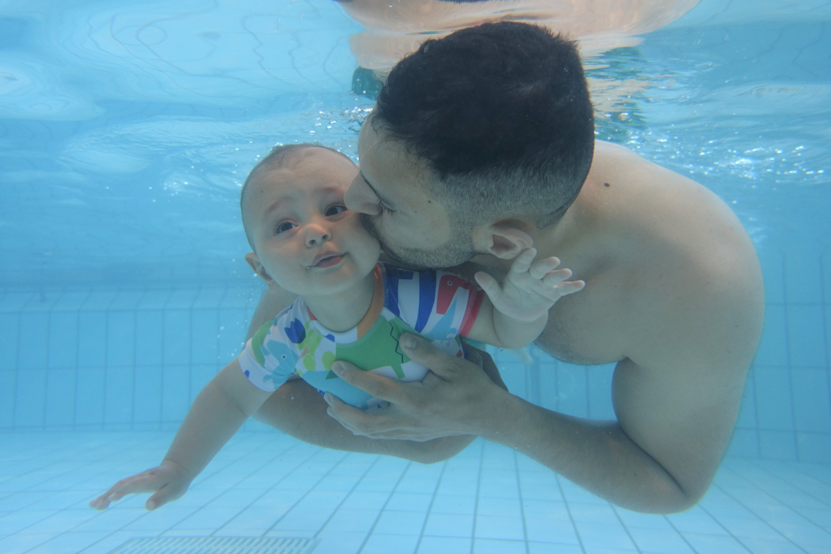 Man and baby underwater